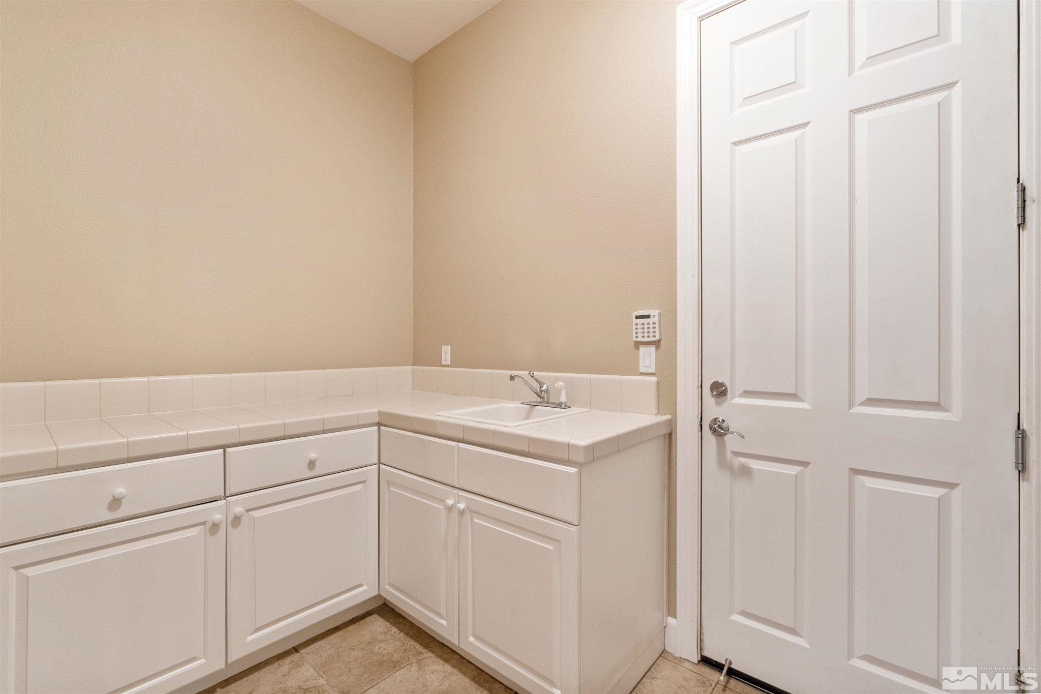 2630 Strathmore Court Reno, NV 89521 - Photo 34 of 40 a view of a kitchen with white cabinets