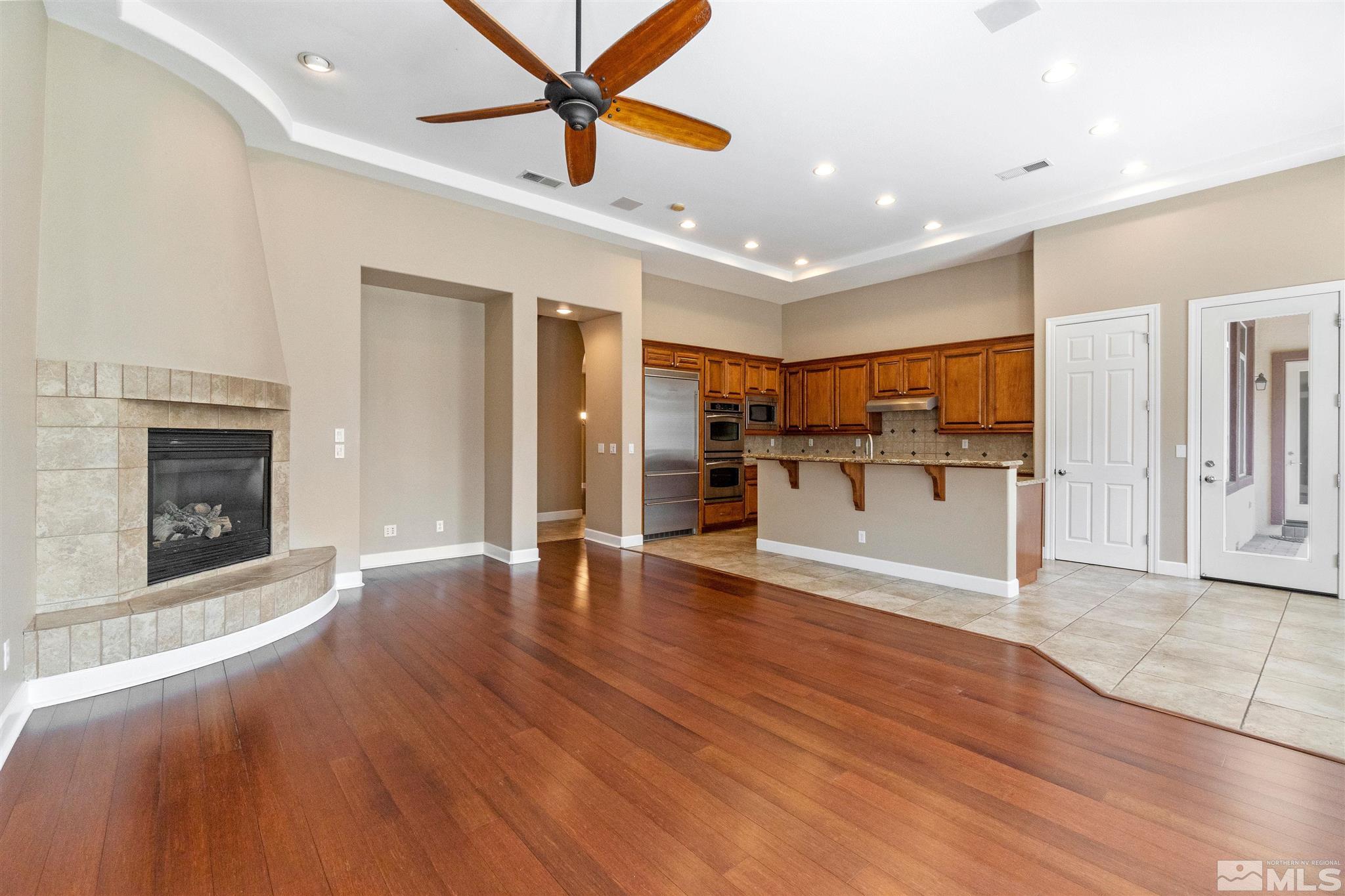 2630 Strathmore Court Reno, NV 89521 - Photo 7 of 40 a view of a kitchen with a sink a refrigerator and a fireplace