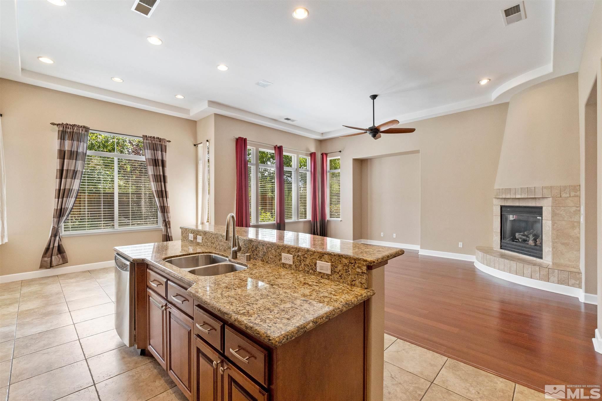 2630 Strathmore Court Reno, NV 89521 - Photo 10 of 40 a kitchen with granite countertop a sink and a stove