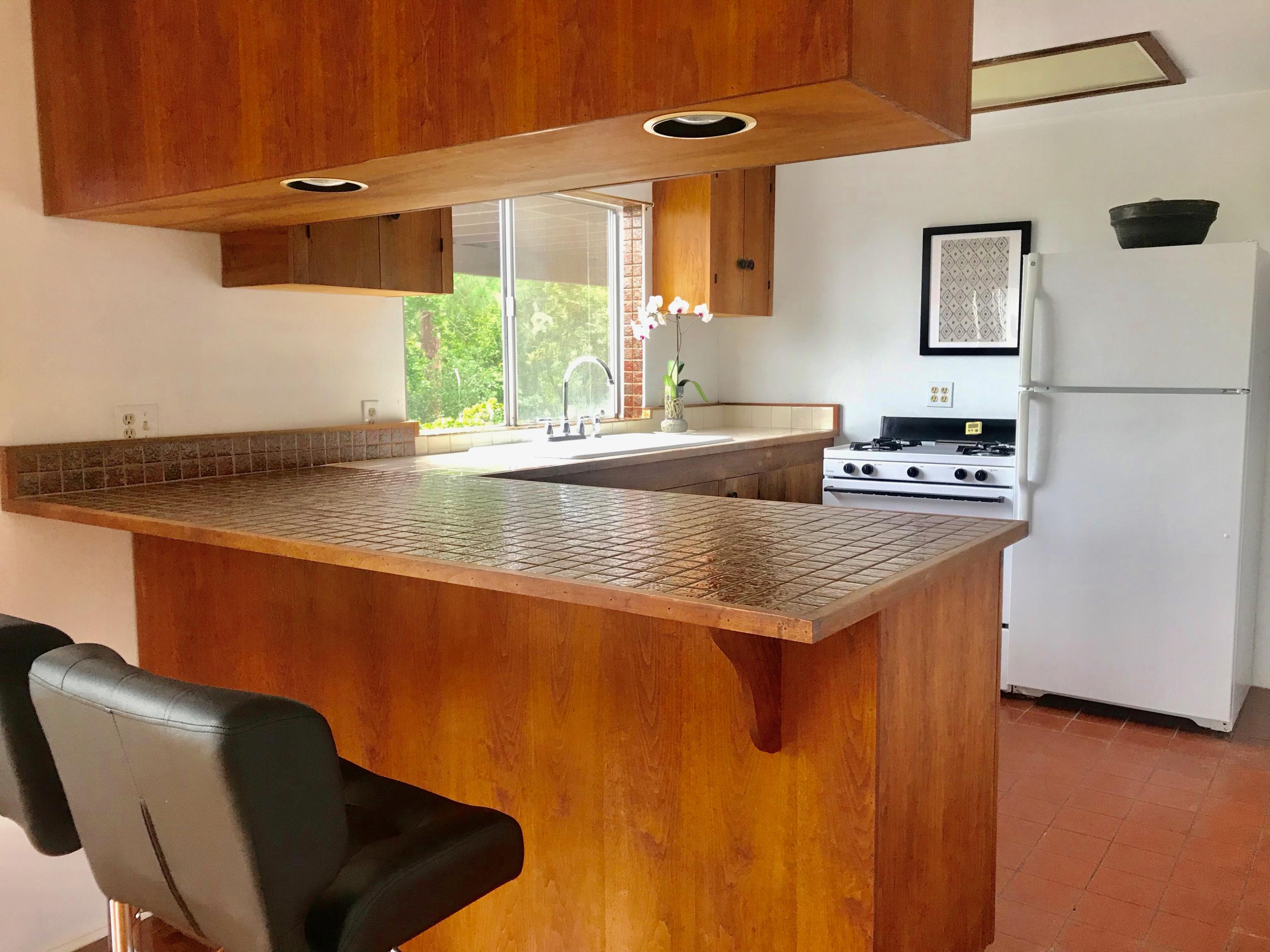 2261 Las Canoas Road Santa Barbara, CA 93105 - Photo 27 of 42 a kitchen with granite countertop sink stove and refrigerator