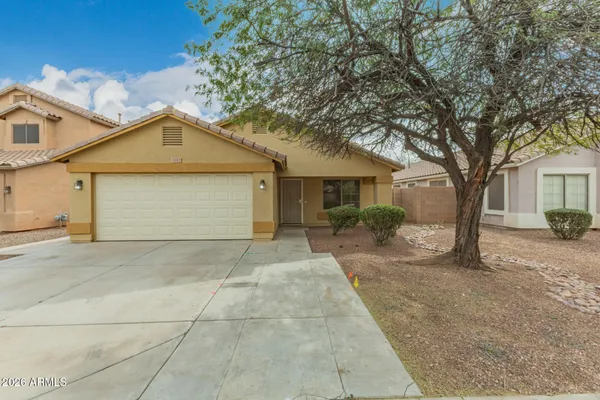 a view of a house with a yard and garage
