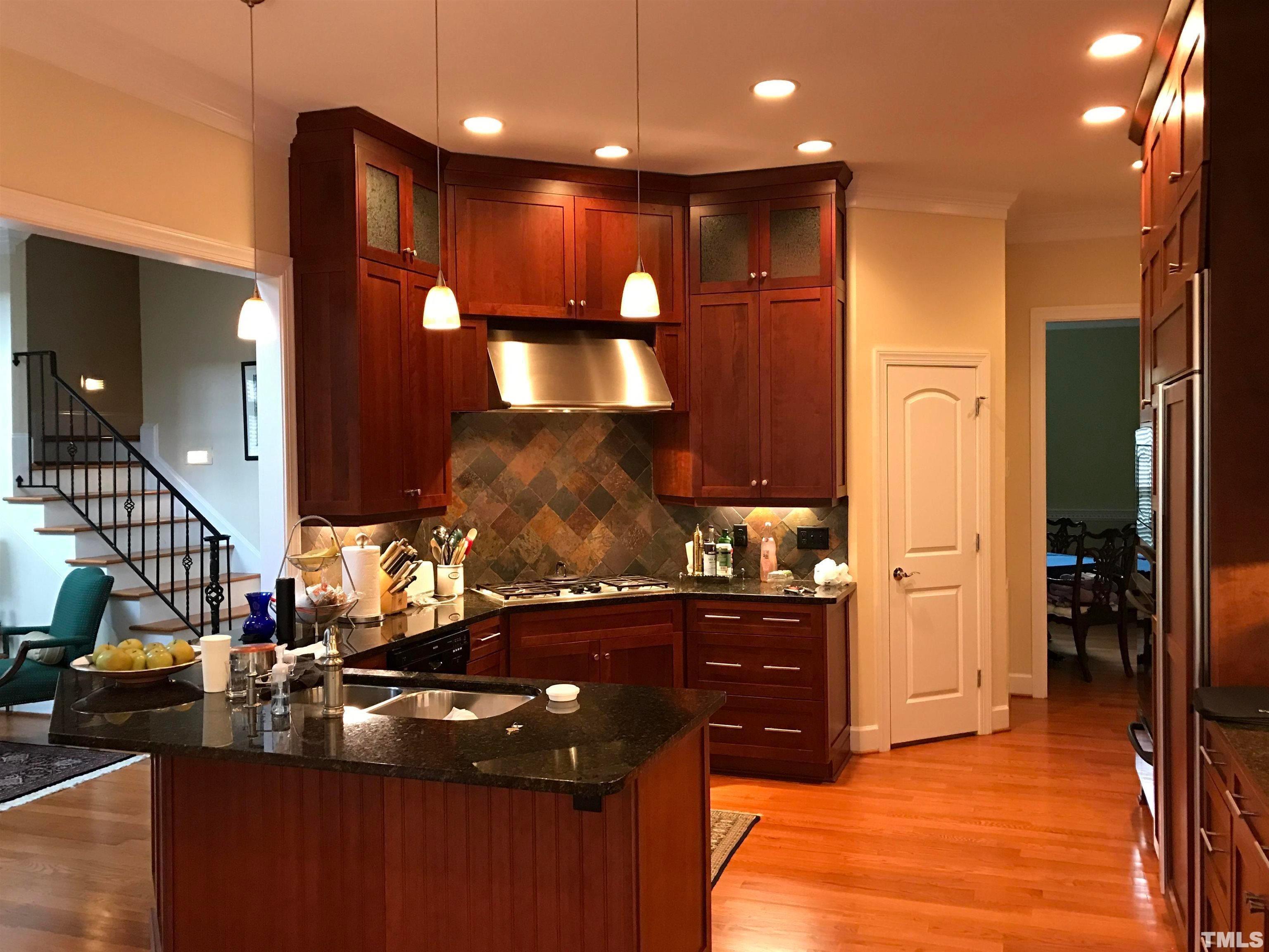 3309 Darien Drive Raleigh, NC 27607 - Photo 2 of 7 a kitchen with stainless steel appliances kitchen island granite countertop a sink counter space and cabinets