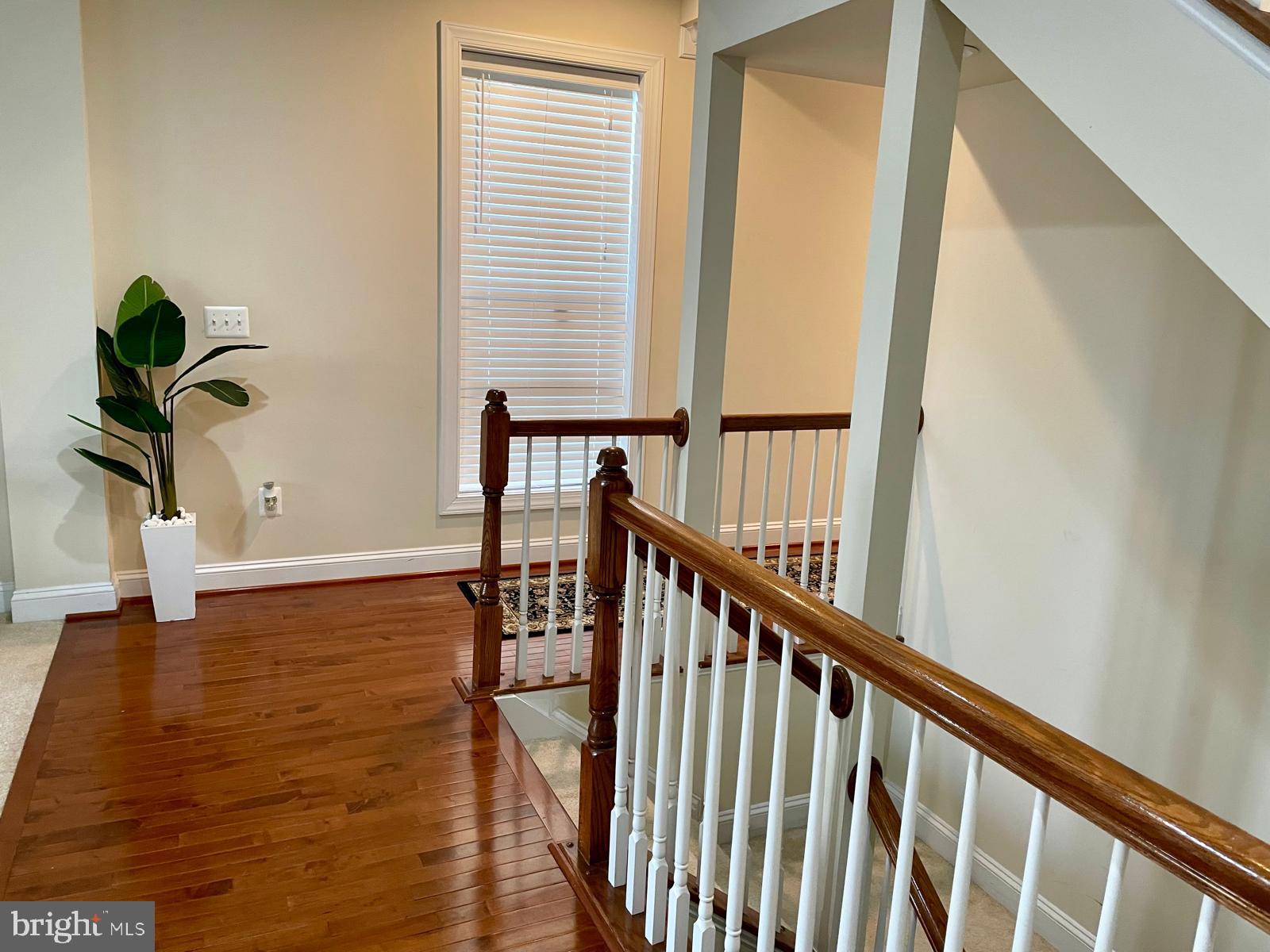 22225 Falling Terrace Ashburn, VA 20148 - Photo 9 of 30 a view of staircase with wooden floor and stairs