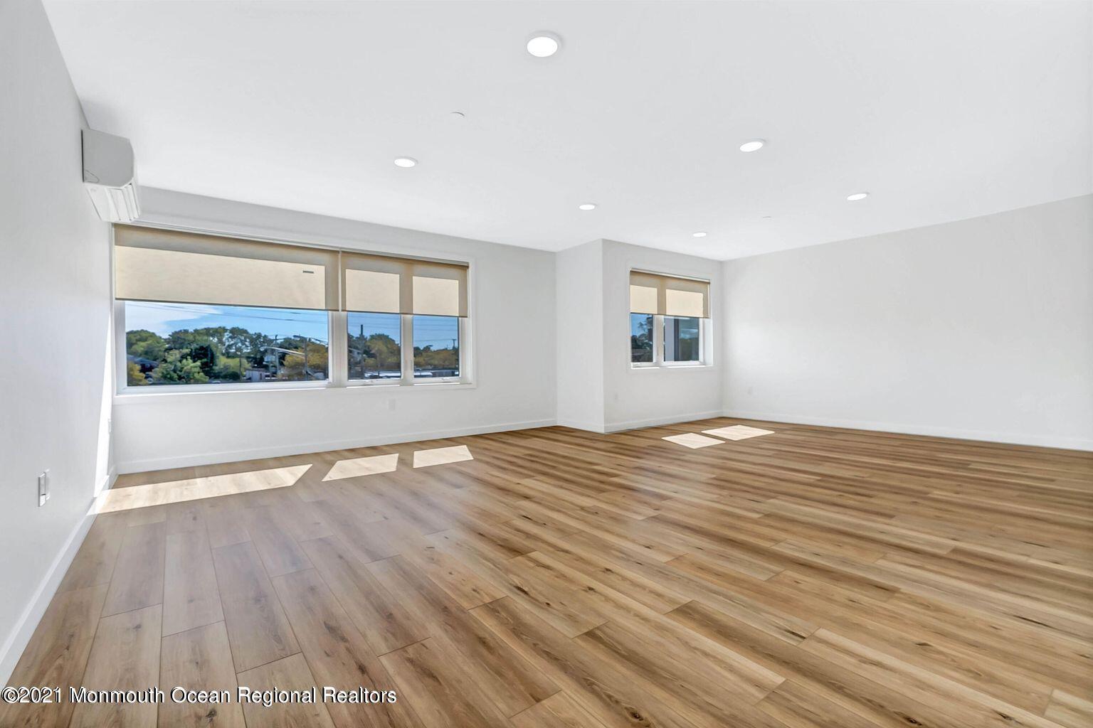 131 Brighton Avenue, Unit 208 Long Branch, NJ 07740 - Photo 12 of 30 a view of empty room with wooden floor and fan