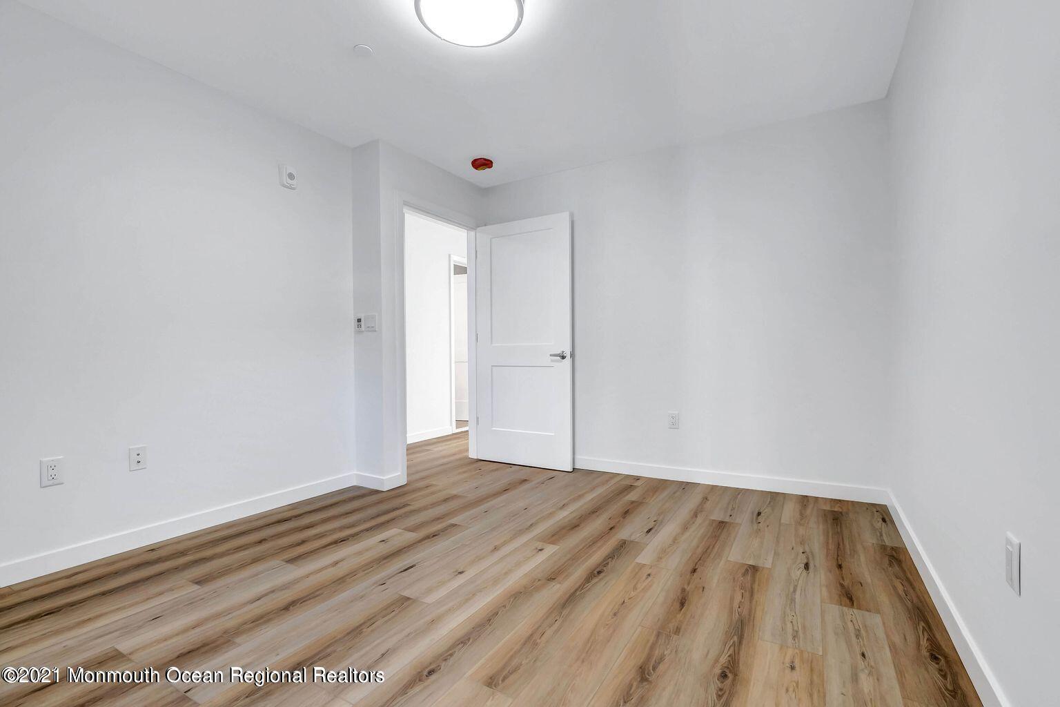 131 Brighton Avenue, Unit 208 Long Branch, NJ 07740 - Photo 15 of 30 a view of room with wooden floor