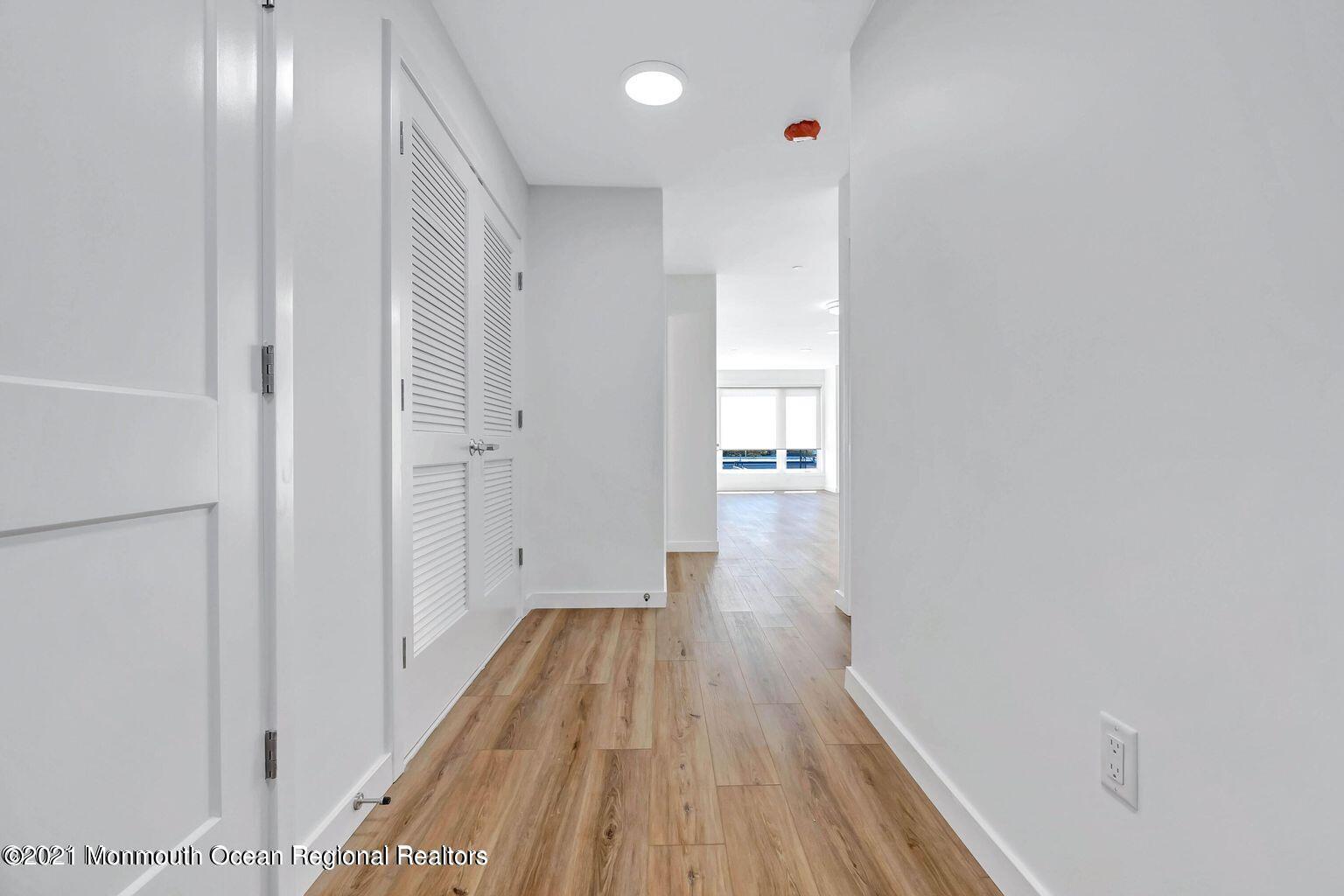 131 Brighton Avenue, Unit 208 Long Branch, NJ 07740 - Photo 17 of 30 a view of a hallway with wooden floor and staircase