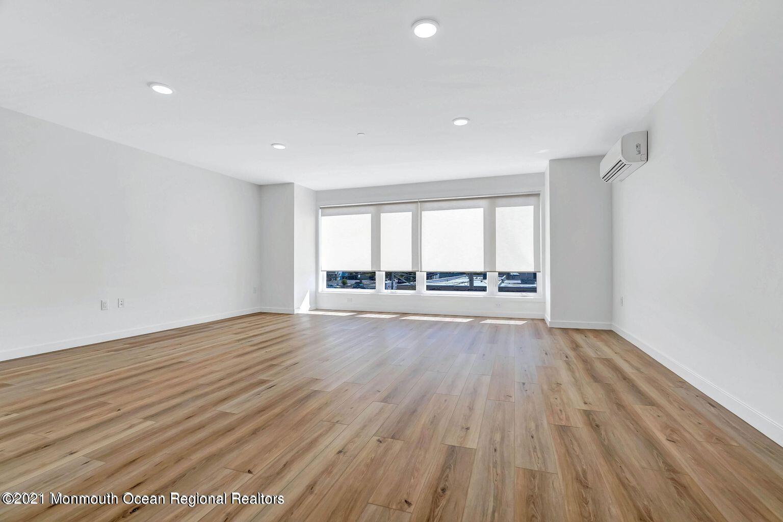 131 Brighton Avenue, Unit 208 Long Branch, NJ 07740 - Photo 18 of 30 wooden floor in an empty room with a window