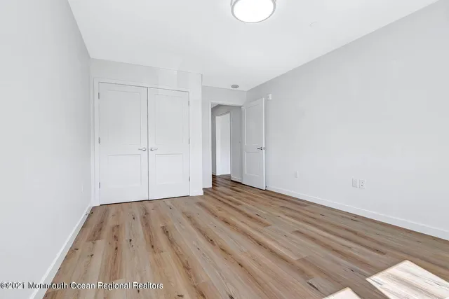 a view of room with wooden floor