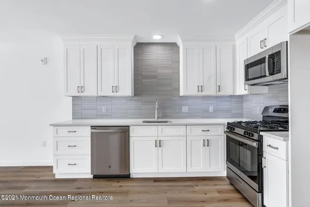 a kitchen with stainless steel appliances granite countertop a stove and a microwave