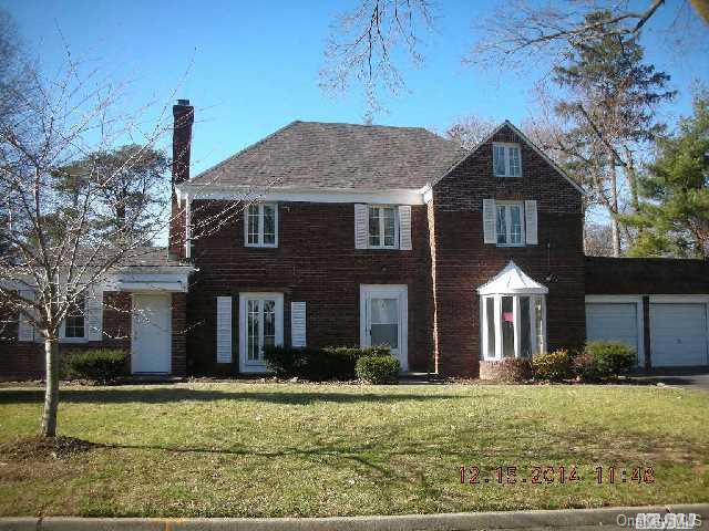 9 Pickwick Road Manhasset, NY 11030 - Photo 1 of 1 a front view of a house with a yard