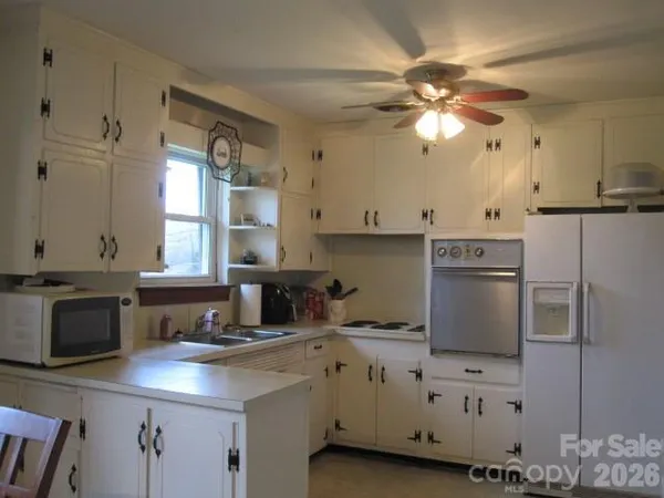 a kitchen with a sink cabinets and window