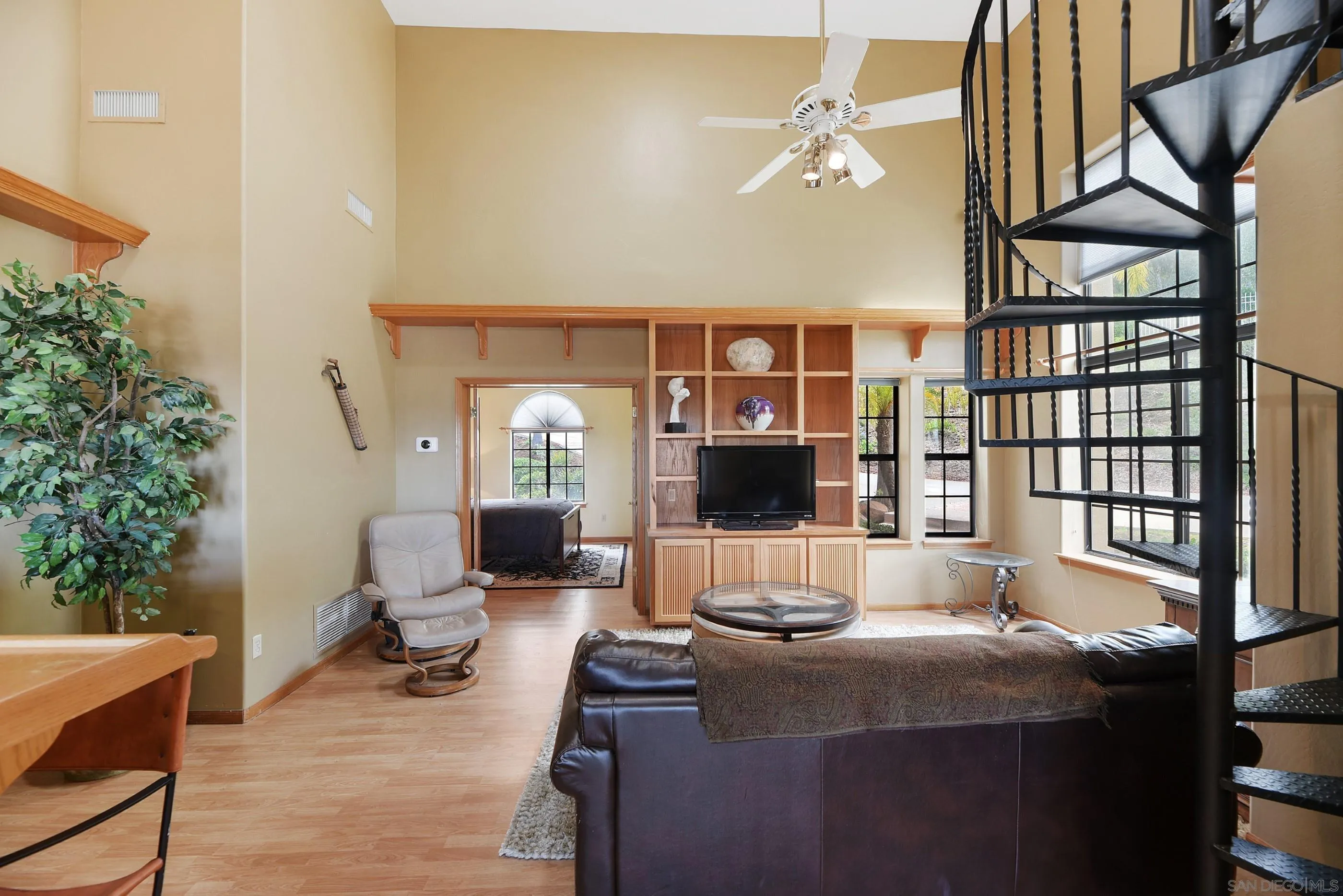 12963 Glen Circle Road Poway, CA 92064 - Photo 48 of 75 a living room with furniture a flat screen tv and a floor to ceiling window
