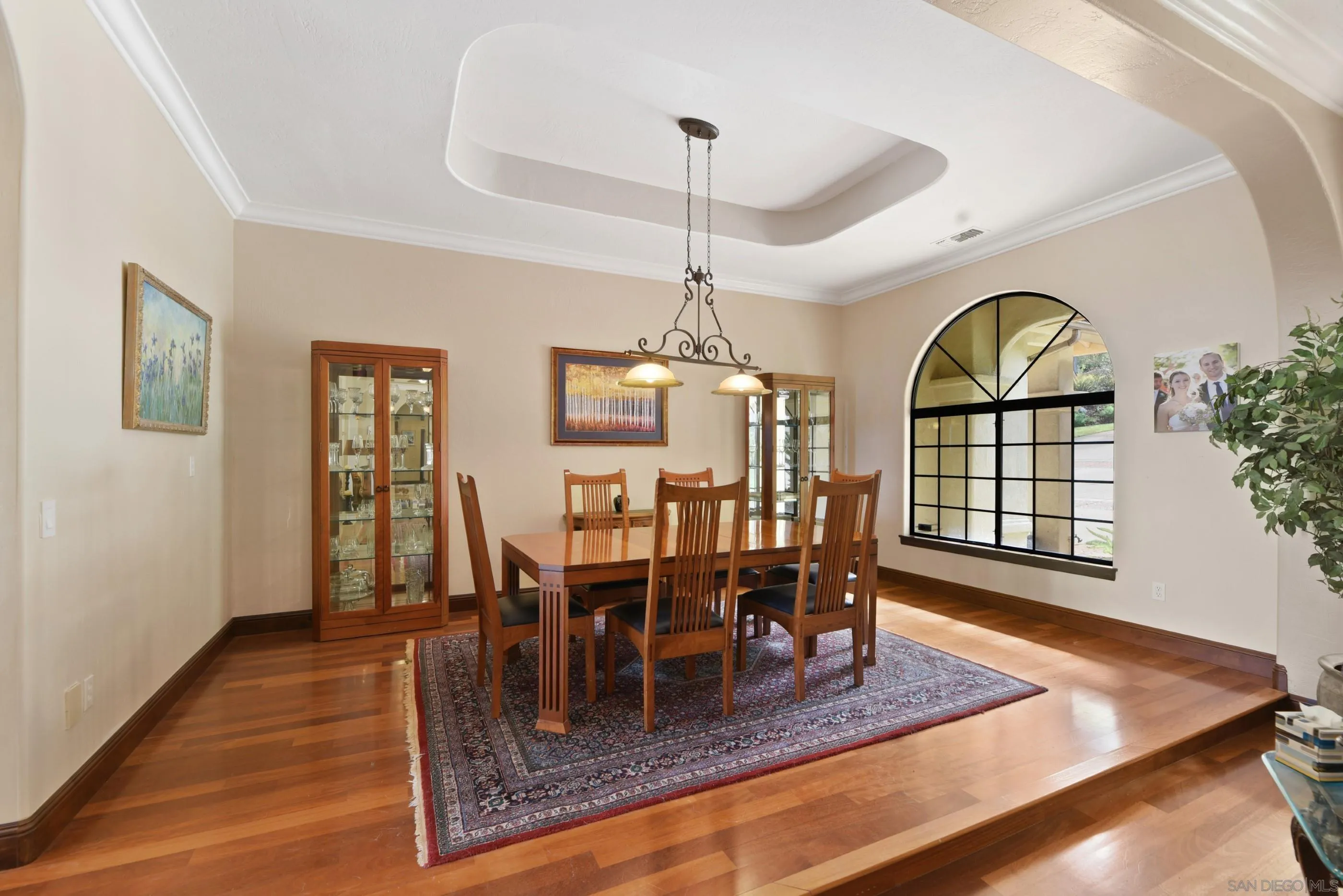 12963 Glen Circle Road Poway, CA 92064 - Photo 10 of 75 a dining room with wooden floor a chandelier a wooden table and chairs