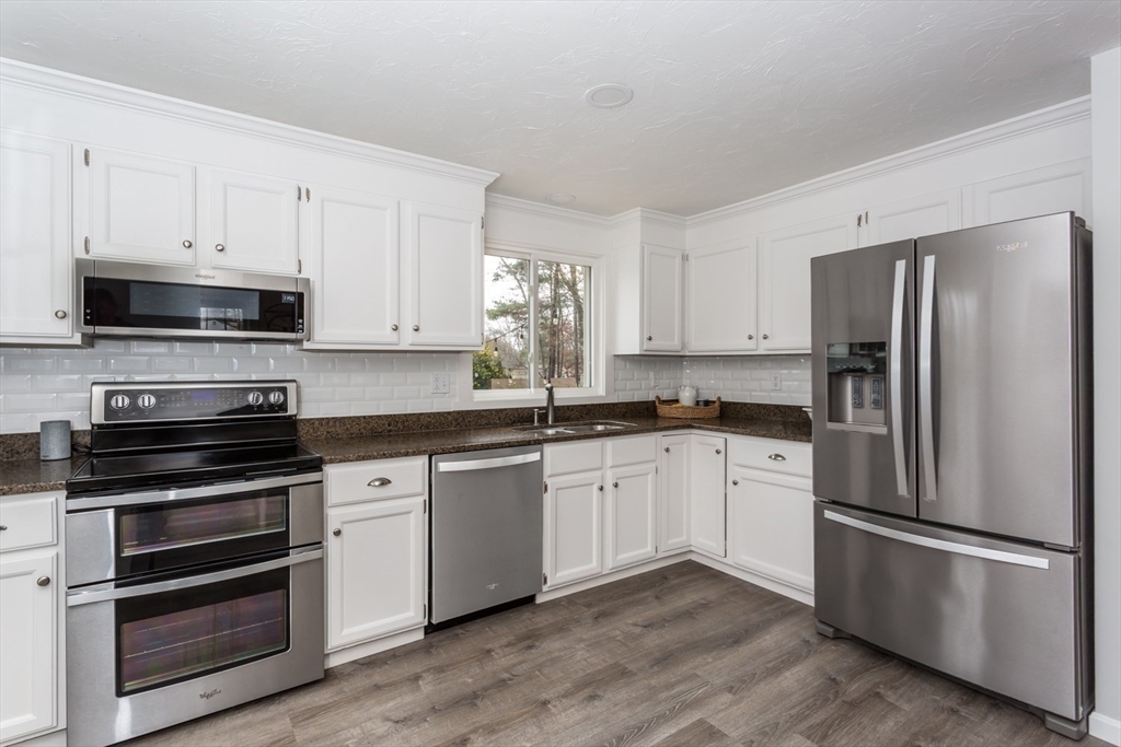 7 Glenwood Road Franklin, MA 02038 - Photo 11 of 46 a kitchen with granite countertop white cabinets and stainless steel appliances