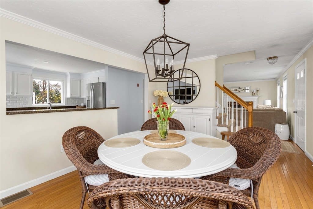 7 Glenwood Road Franklin, MA 02038 - Photo 13 of 46 a dining room with furniture a chandelier and wooden floor