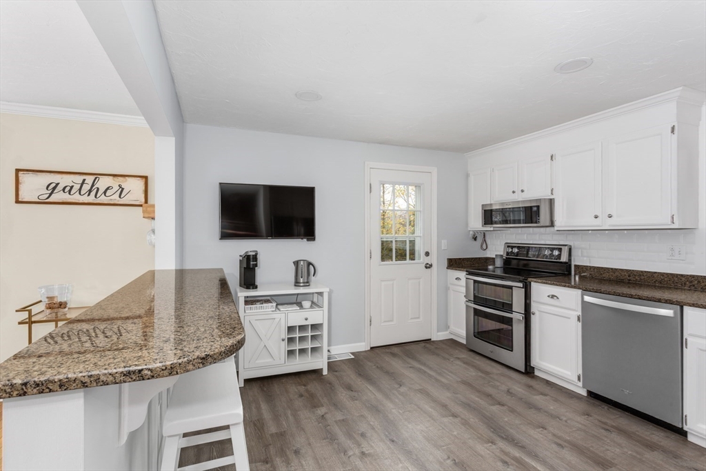7 Glenwood Road Franklin, MA 02038 - Photo 2 of 46 a kitchen with stainless steel appliances granite countertop a stove top oven a sink dishwasher and a refrigerator with wooden floor