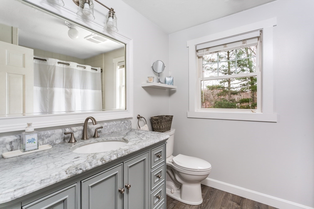 7 Glenwood Road Franklin, MA 02038 - Photo 22 of 46 a bathroom with a granite countertop toilet a sink a window and mirror