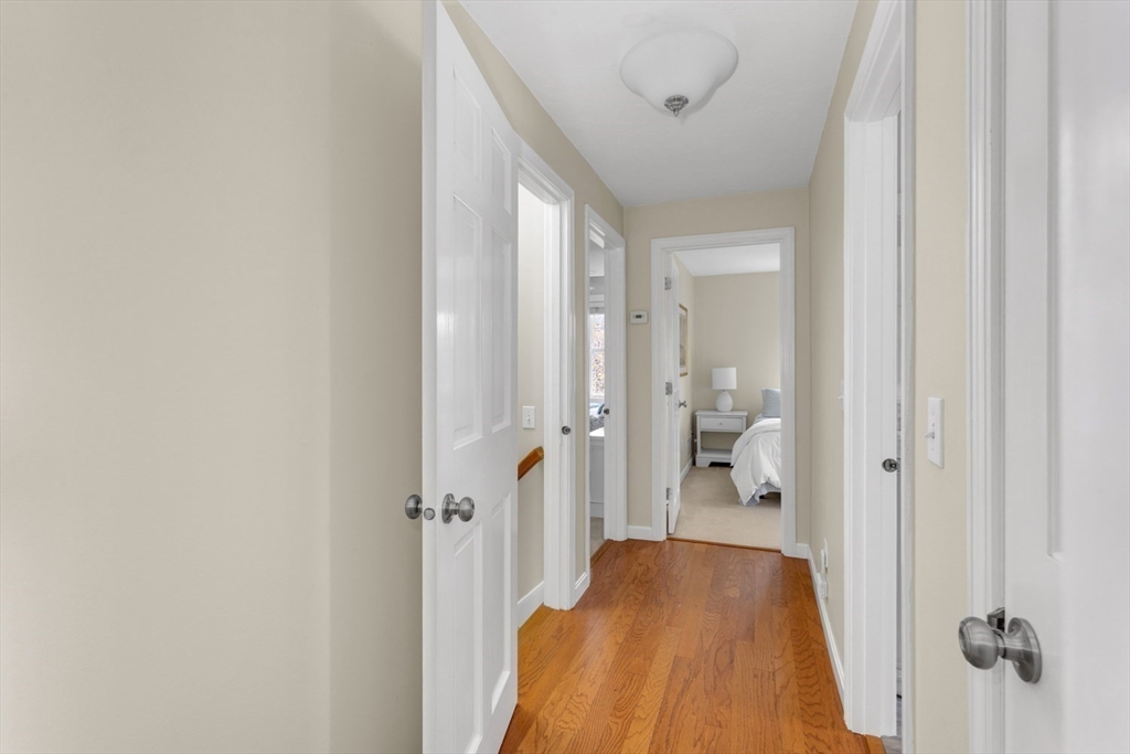 7 Glenwood Road Franklin, MA 02038 - Photo 23 of 46 a view of a hallway with wooden floor and a bathroom
