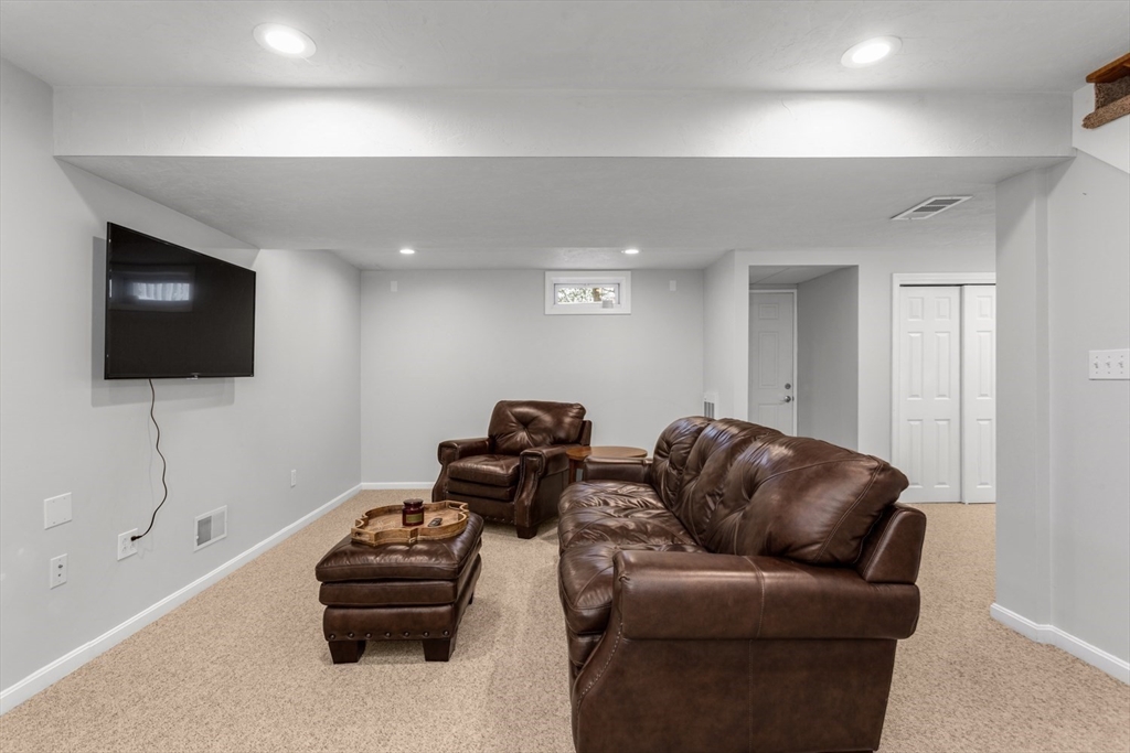 7 Glenwood Road Franklin, MA 02038 - Photo 29 of 46 a living room with furniture and a flat screen tv