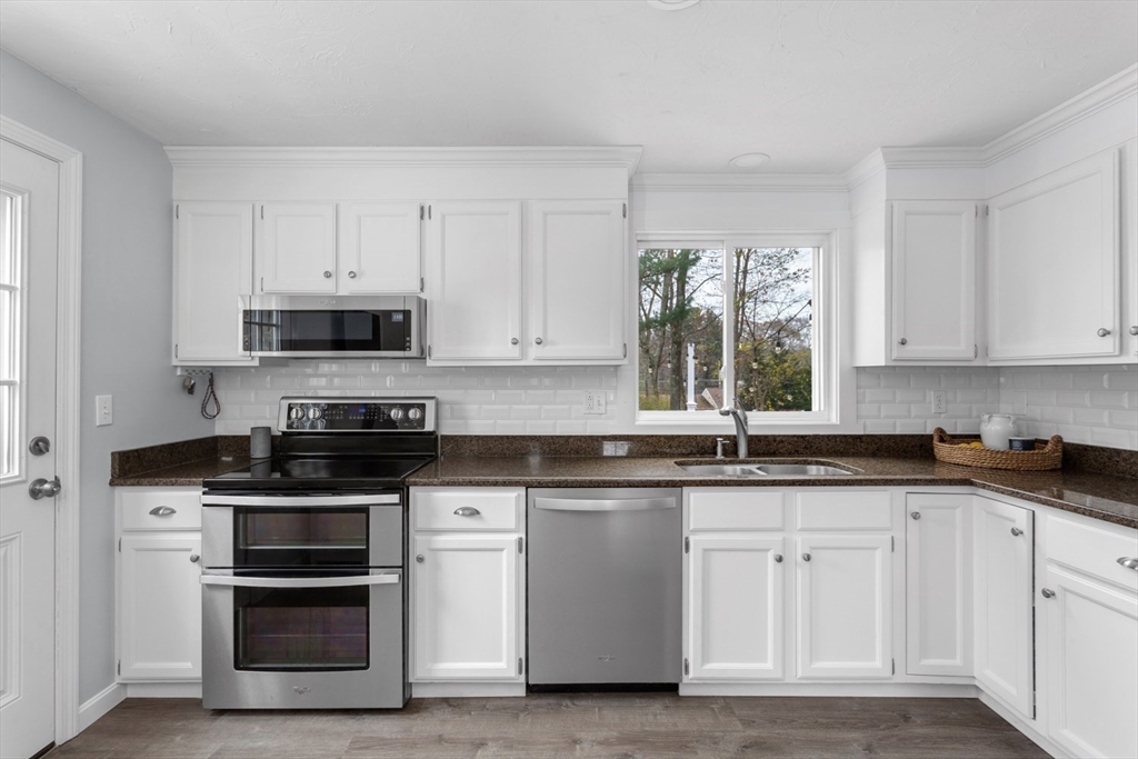 7 Glenwood Road Franklin, MA 02038 - Photo 8 of 46 a kitchen with white cabinets stainless steel appliances and sink