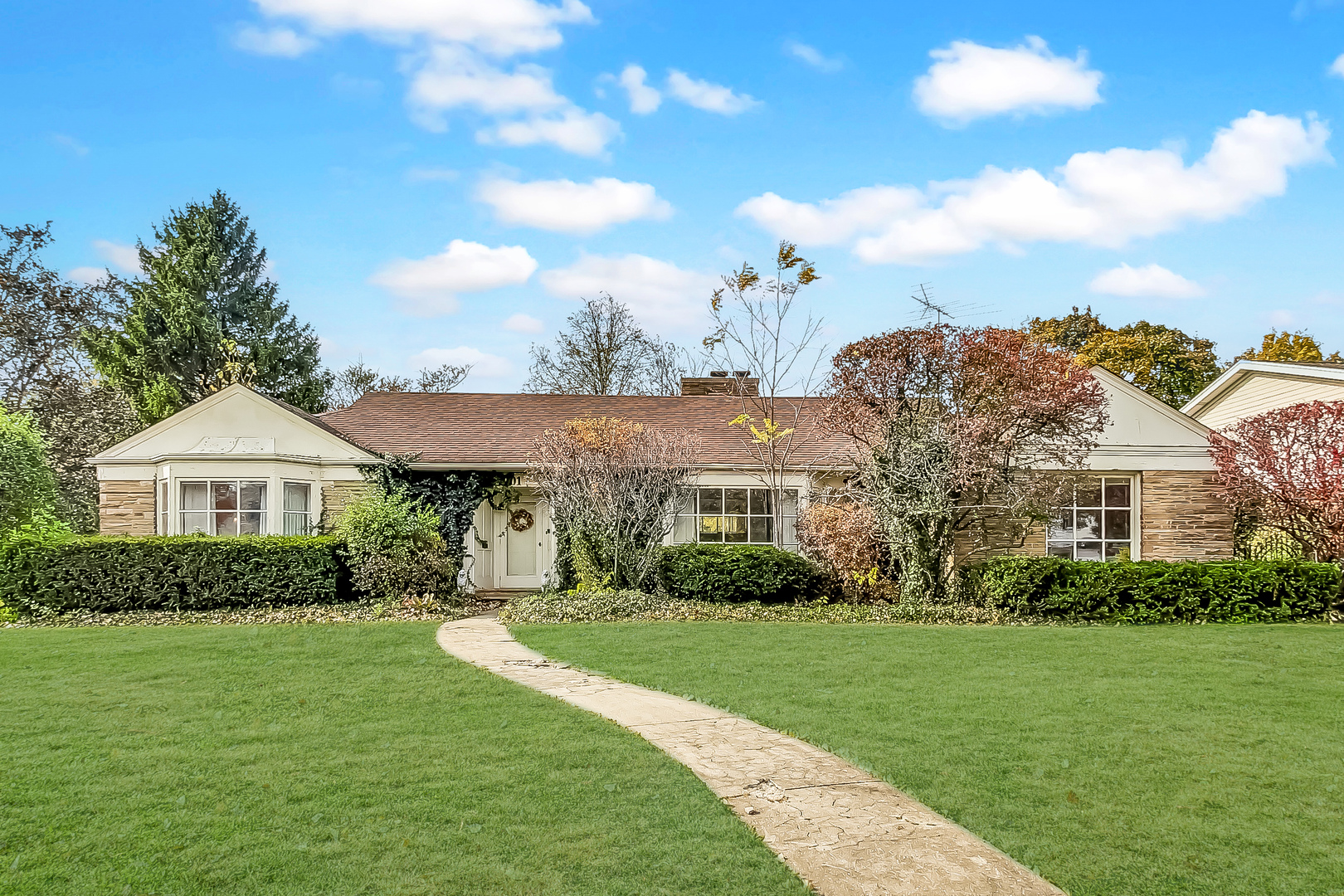 a front view of a house with a garden