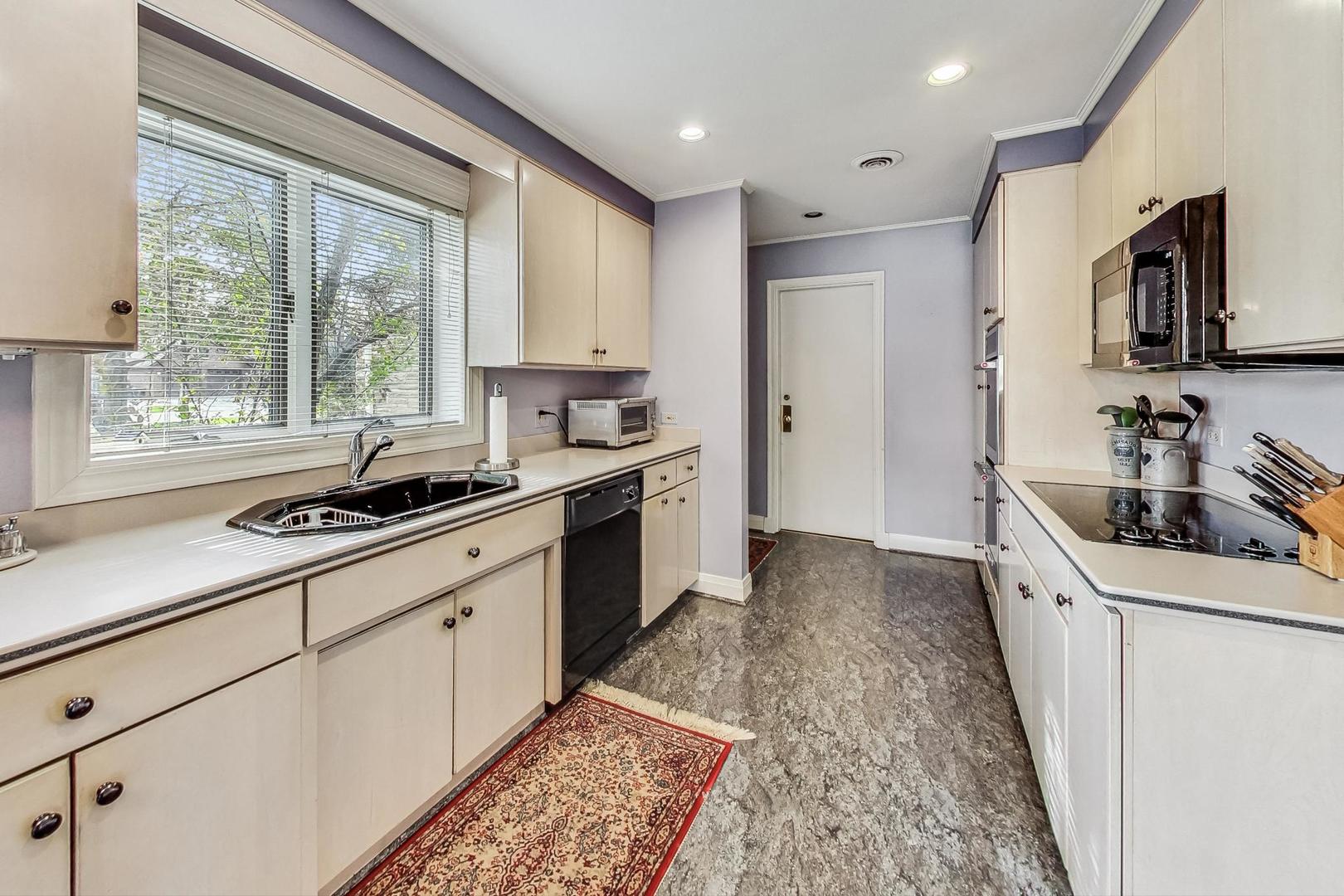 701 East Avenue Park Ridge, IL 60068 - Photo 15 of 37 a kitchen with stainless steel appliances a sink stove and cabinets