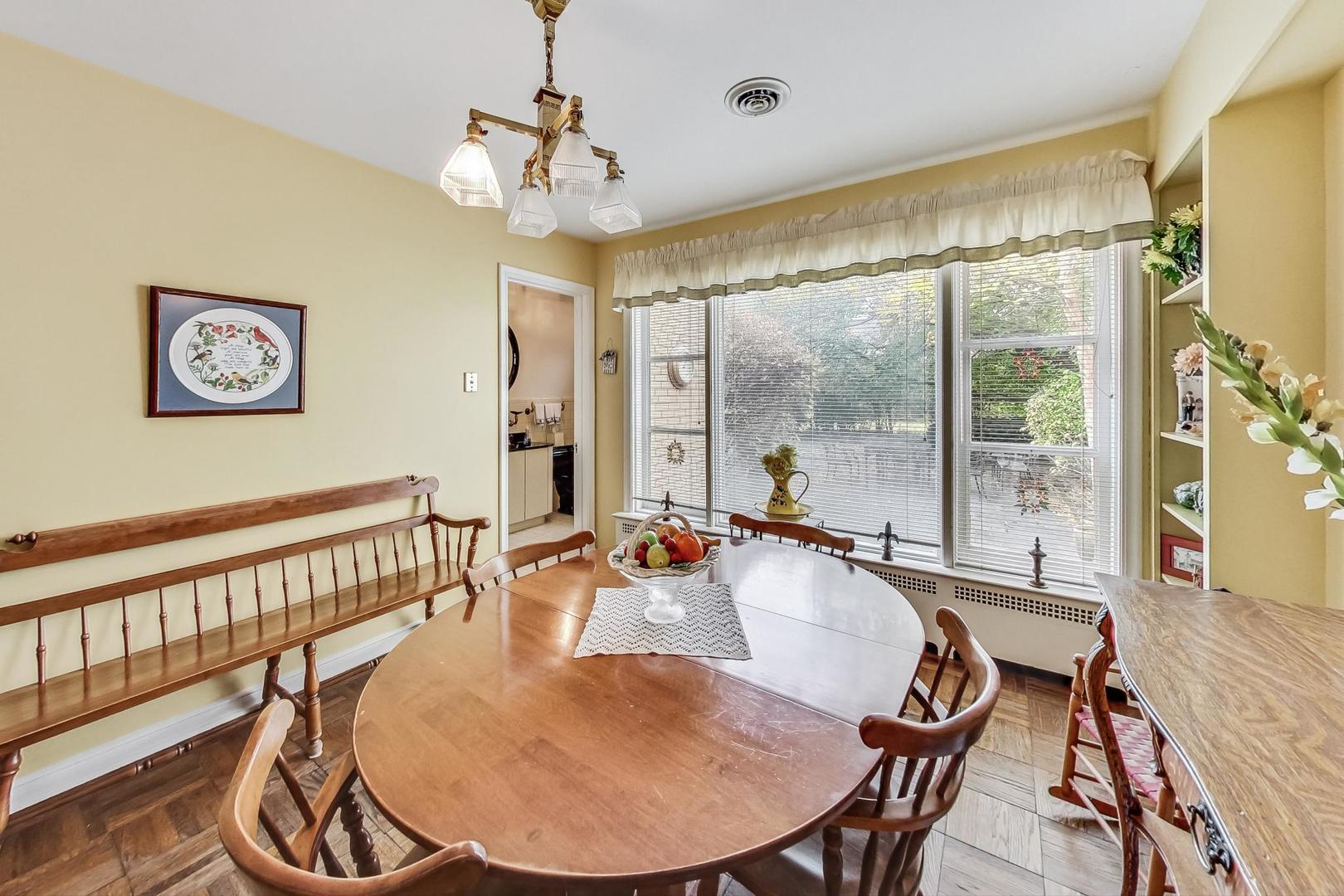 701 East Avenue Park Ridge, IL 60068 - Photo 17 of 37 a dining room with furniture a chandelier and window