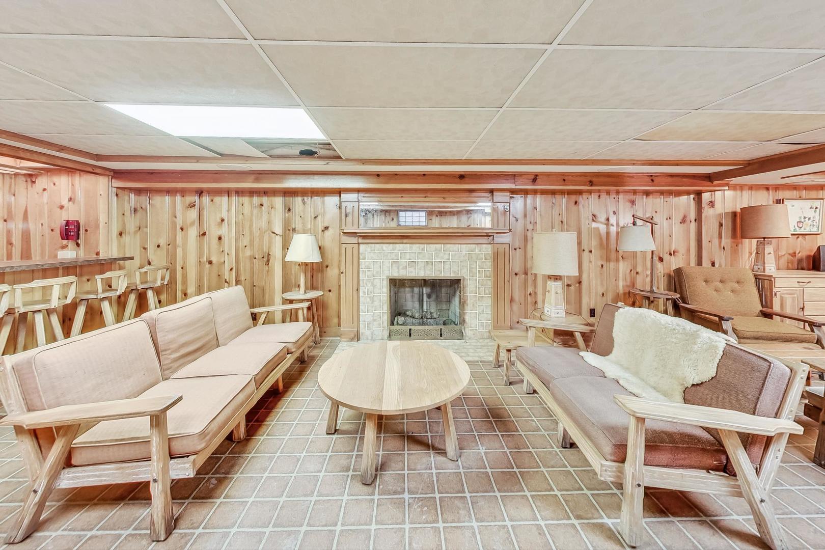 701 East Avenue Park Ridge, IL 60068 - Photo 24 of 37 a living room with furniture a chandelier and a fireplace