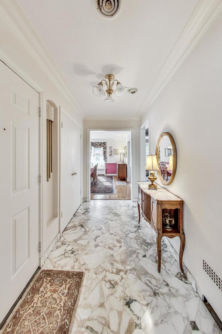 701 East Avenue Park Ridge, IL 60068 - Photo 3 of 37 a view of a hallway to a livingroom with furniture