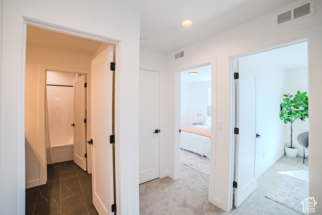 342 Perrine Drive Midvale, UT 84047 - Photo 26 of 37 Recessed ceiling lighting, white interior doors with matte black hardware, light-toned carpeting, and dark-toned floor tiling