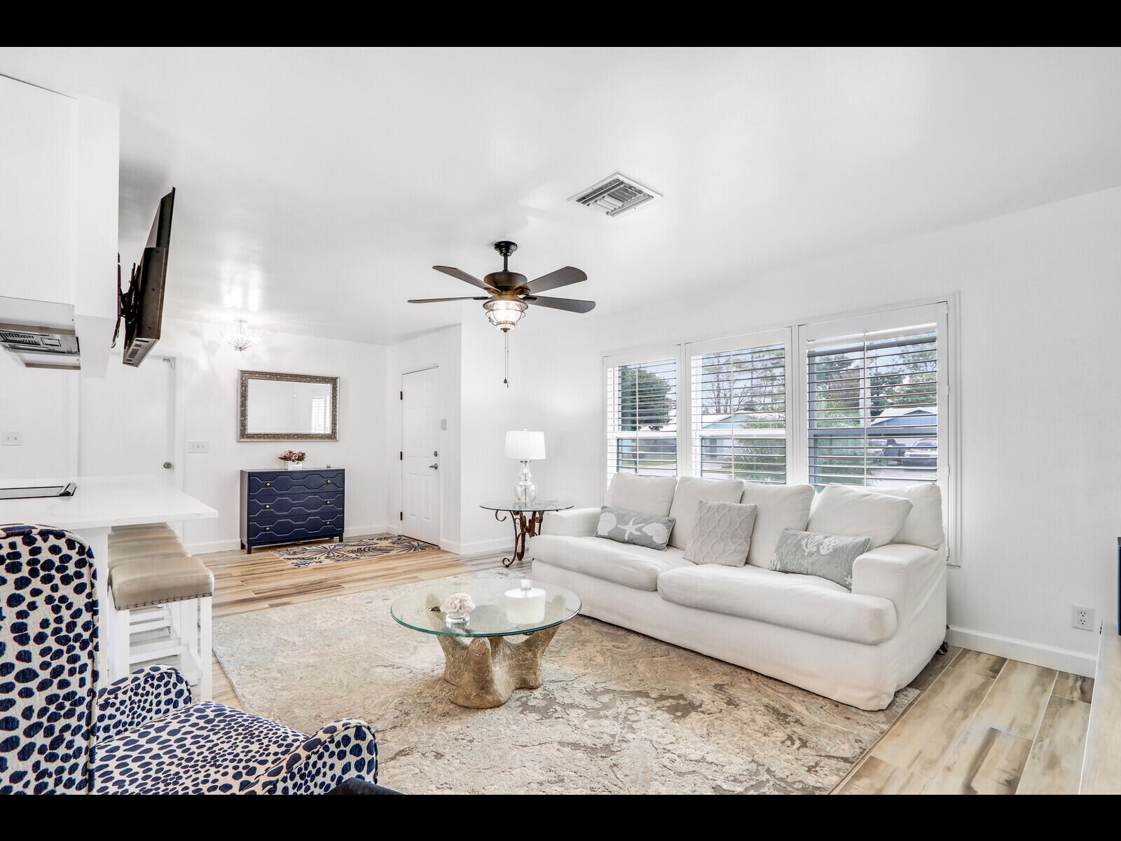 609 Oak Terrace Jupiter, FL 33458 - Photo 8 of 28 a living room with furniture a flat screen tv and a large window