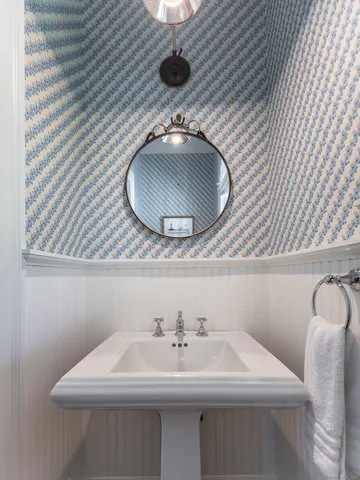 a bathroom with a sink a mirror and vanity