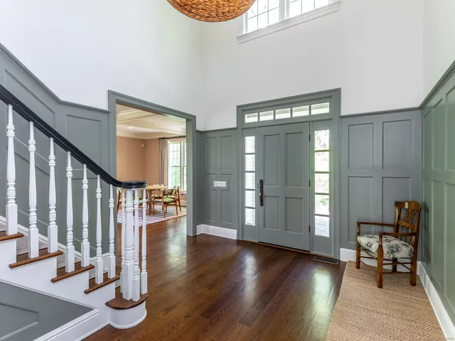 a view of an entryway with wooden floor and a window