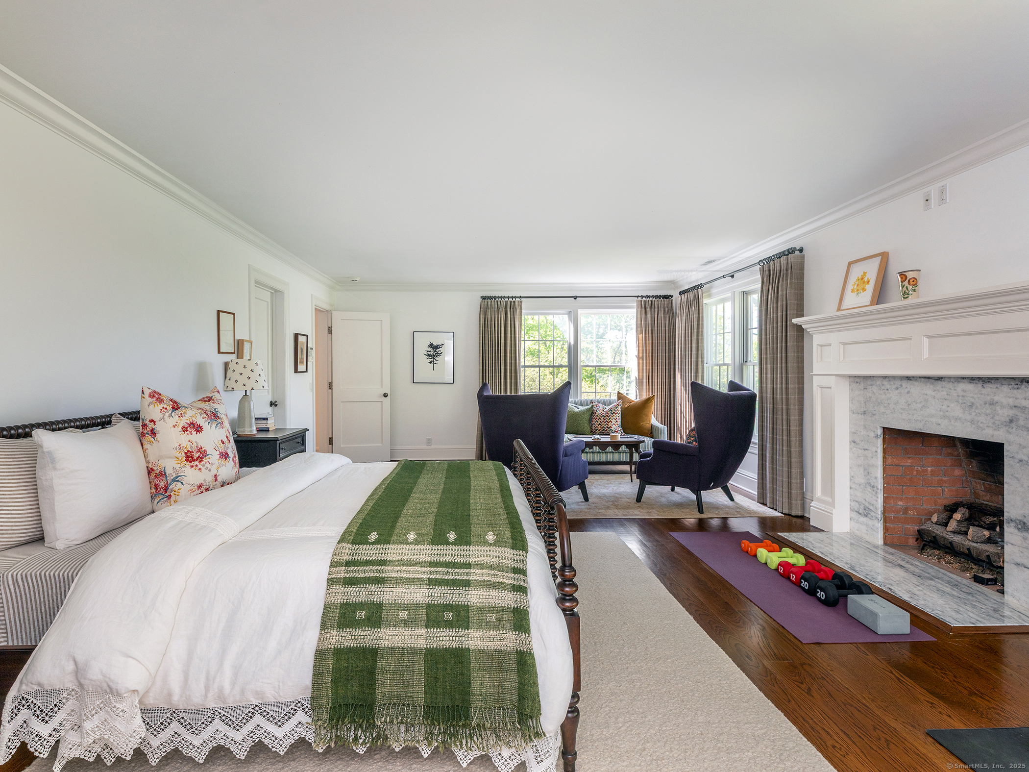 143 Tophet Road Roxbury, CT 06783 - Photo 19 of 40 a bedroom with a bed a table and a fireplace