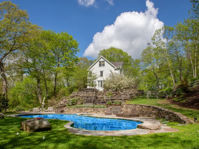a view of a house with a yard and sitting area