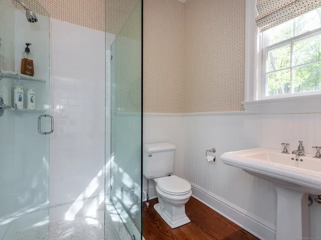 a white toilet sitting next to a bathroom sink