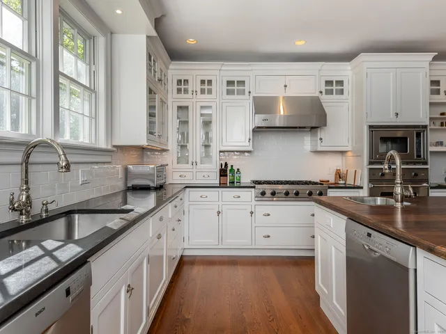 a kitchen with a sink stove and cabinets