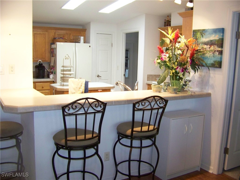 15550 Burnt Store Road, Unit 128 Punta Gorda, FL 33955 - Photo 15 of 50 a dining room table chairs and a potted plant