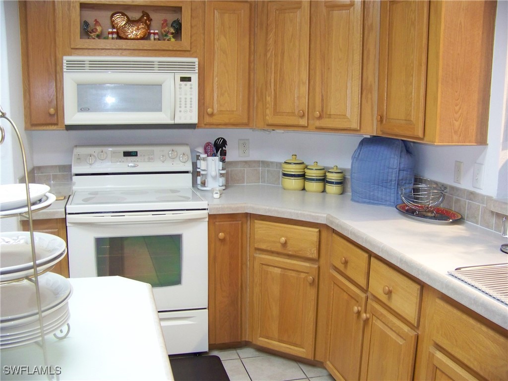 15550 Burnt Store Road, Unit 128 Punta Gorda, FL 33955 - Photo 17 of 50 a kitchen with sink cabinets and appliances