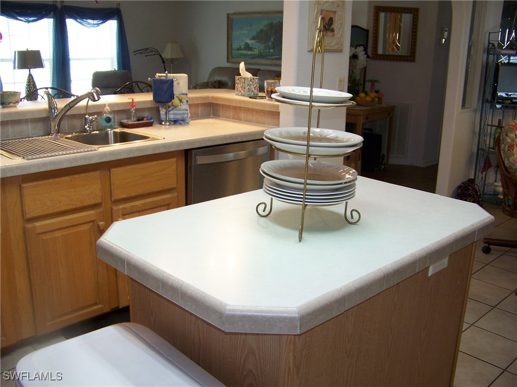 15550 Burnt Store Road, Unit 128 Punta Gorda, FL 33955 - Photo 20 of 50 a kitchen with a sink and white cabinets