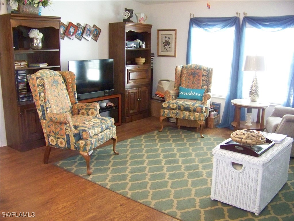 15550 Burnt Store Road, Unit 128 Punta Gorda, FL 33955 - Photo 25 of 50 a living room with furniture and a fireplace