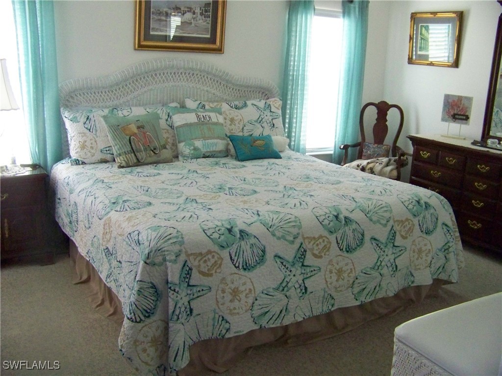 15550 Burnt Store Road, Unit 128 Punta Gorda, FL 33955 - Photo 26 of 50 a bedroom with a bed and a window