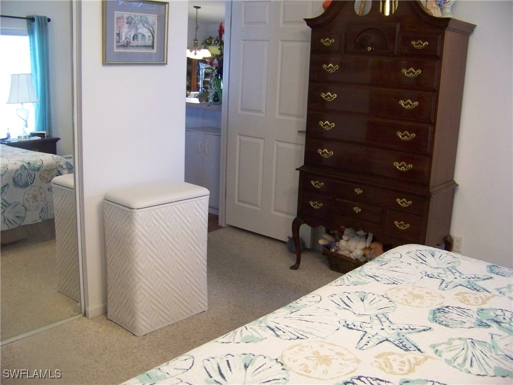 15550 Burnt Store Road, Unit 128 Punta Gorda, FL 33955 - Photo 28 of 50 a bedroom with a bed and a dresser