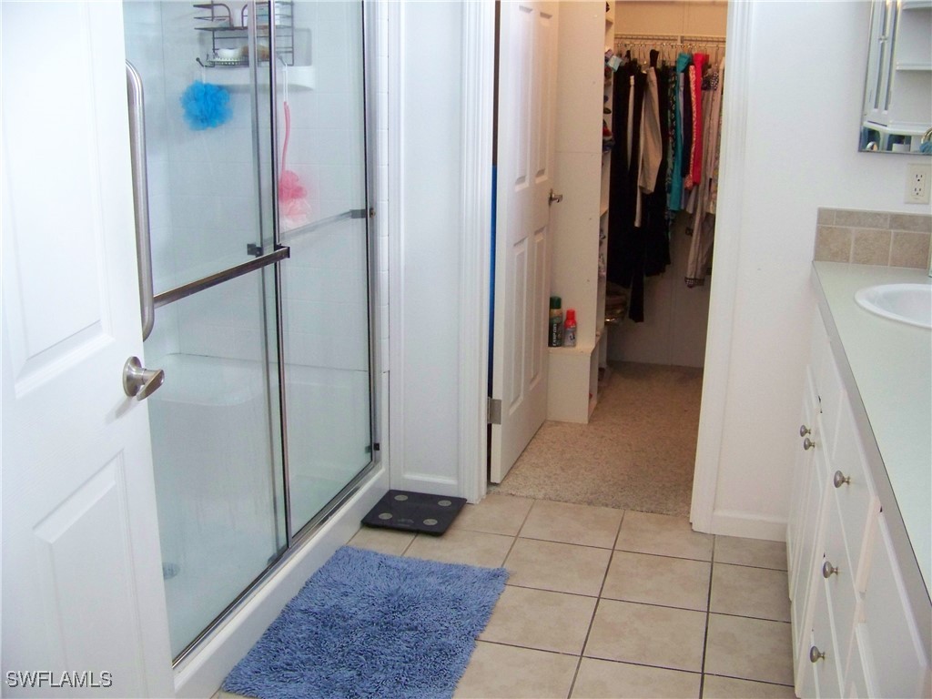 15550 Burnt Store Road, Unit 128 Punta Gorda, FL 33955 - Photo 30 of 50 a view of walk in closet with clothes and shoes