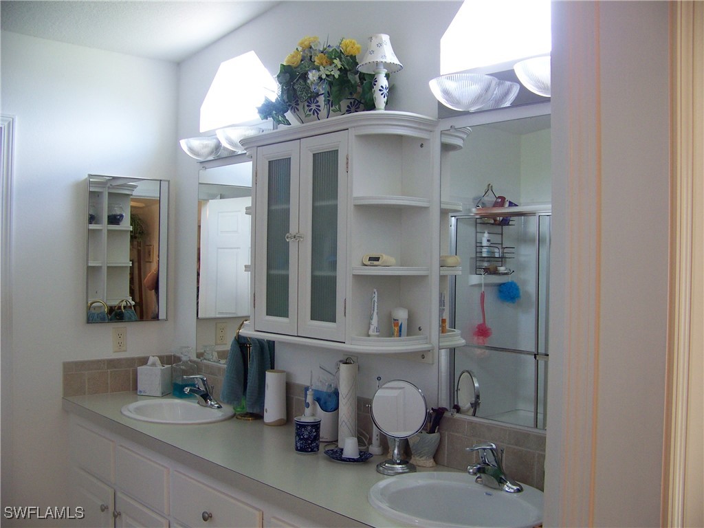 15550 Burnt Store Road, Unit 128 Punta Gorda, FL 33955 - Photo 31 of 50 a bathroom with a sink and a mirror