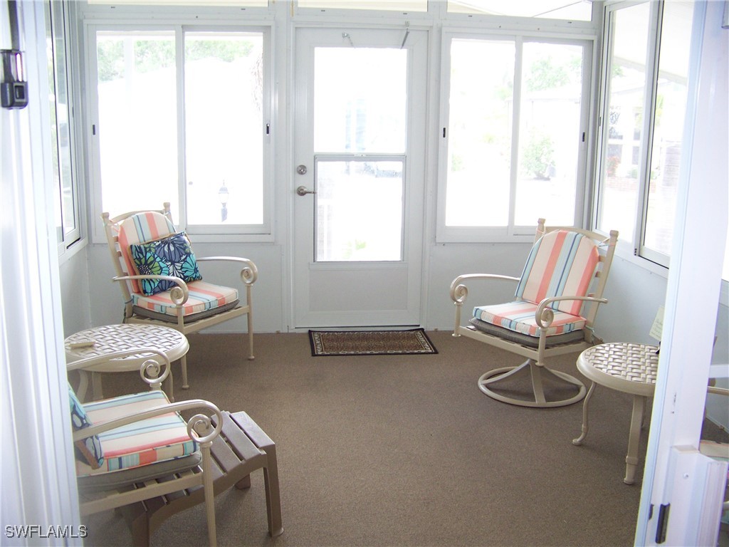 15550 Burnt Store Road, Unit 128 Punta Gorda, FL 33955 - Photo 43 of 50 a living room with furniture and a large window