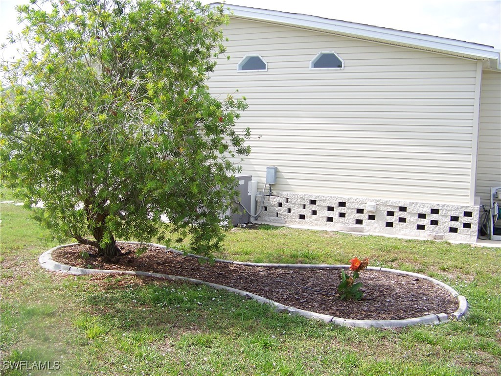 15550 Burnt Store Road, Unit 128 Punta Gorda, FL 33955 - Photo 7 of 50 a backyard of white house with outdoor seating