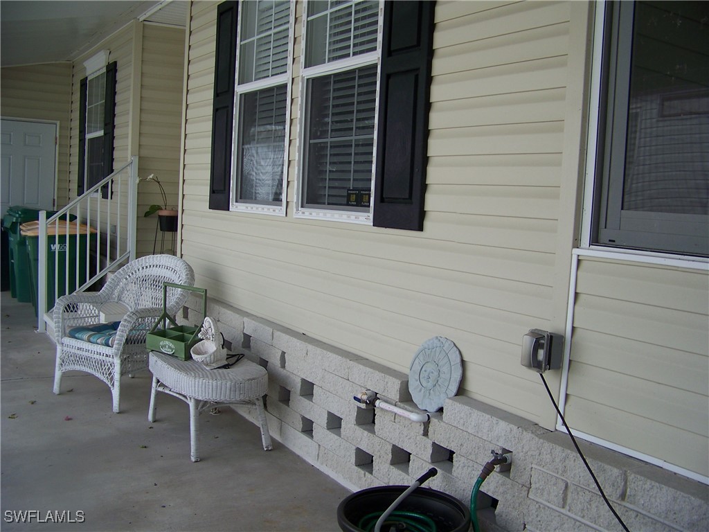 15550 Burnt Store Road, Unit 128 Punta Gorda, FL 33955 - Photo 10 of 50 a view of a patio with table and chairs with an outdoor space