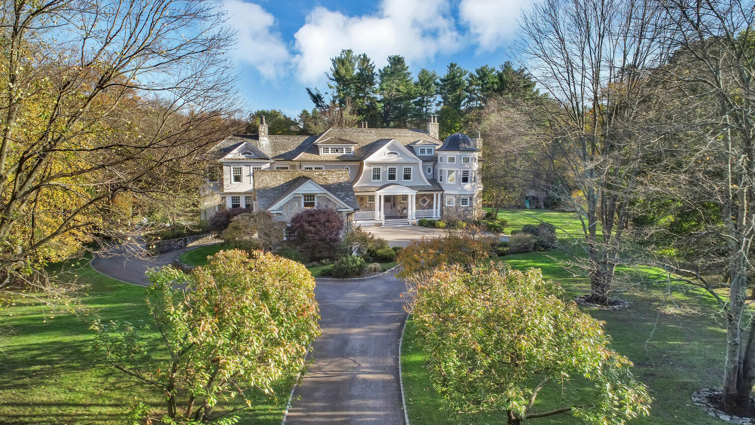 363 West Road New Canaan, CT 06840 - Photo 1 of 68 a aerial view of a house with a yard lake and trees all around