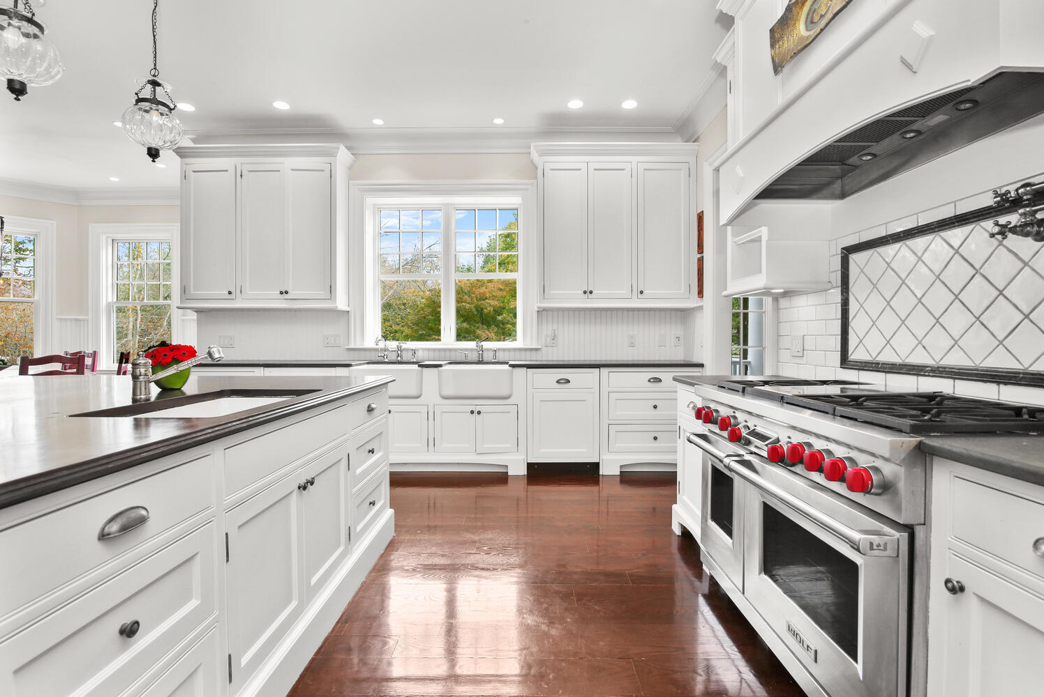 363 West Road New Canaan, CT 06840 - Photo 21 of 68 a kitchen that has a lot of cabinets in it and wooden floor